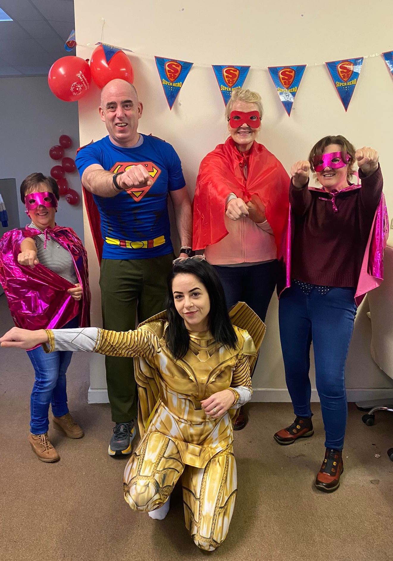 Five ContactCentre.ie staff posing in superhero costumes